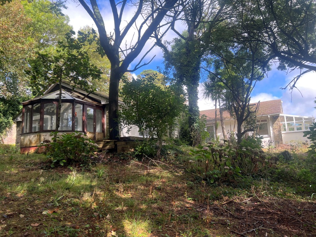 Lot: 148 - DETACHED FOUR-BEDROOM BUNGALOW WITH DOUBLE GARAGE AND GOOD SIZE GROUNDS FOR UPDATING - Rear elevation from bottom of the garden